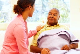 caregiver talking to a senior man